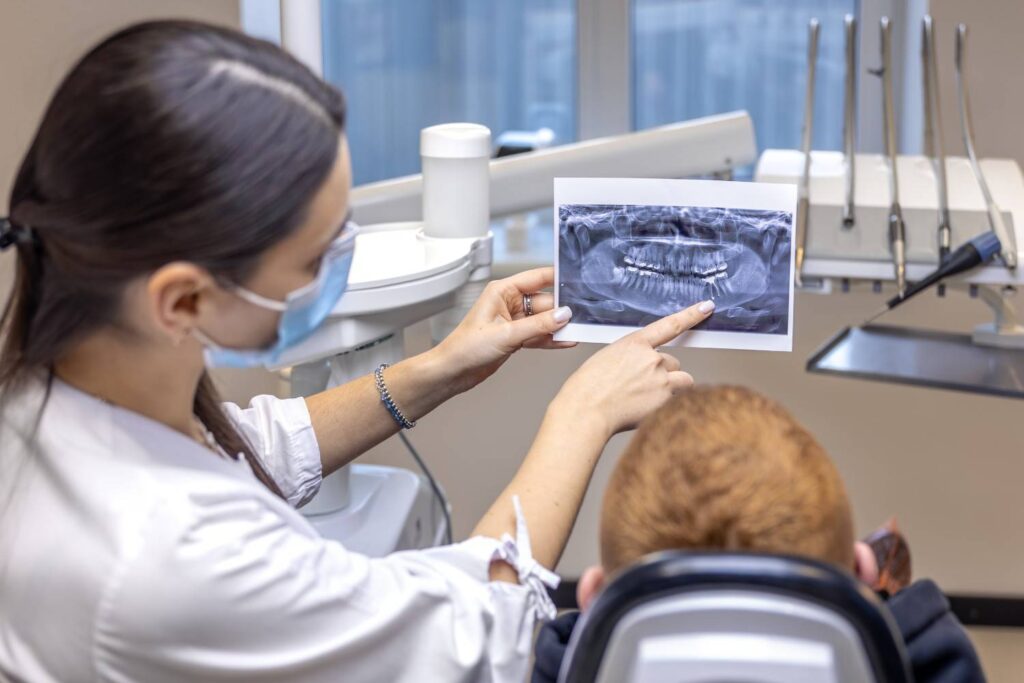 Dentist explaining an X-ray image to a patient in the dental office.